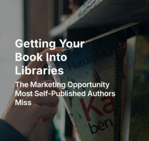 Hand removing book from shelf in library.